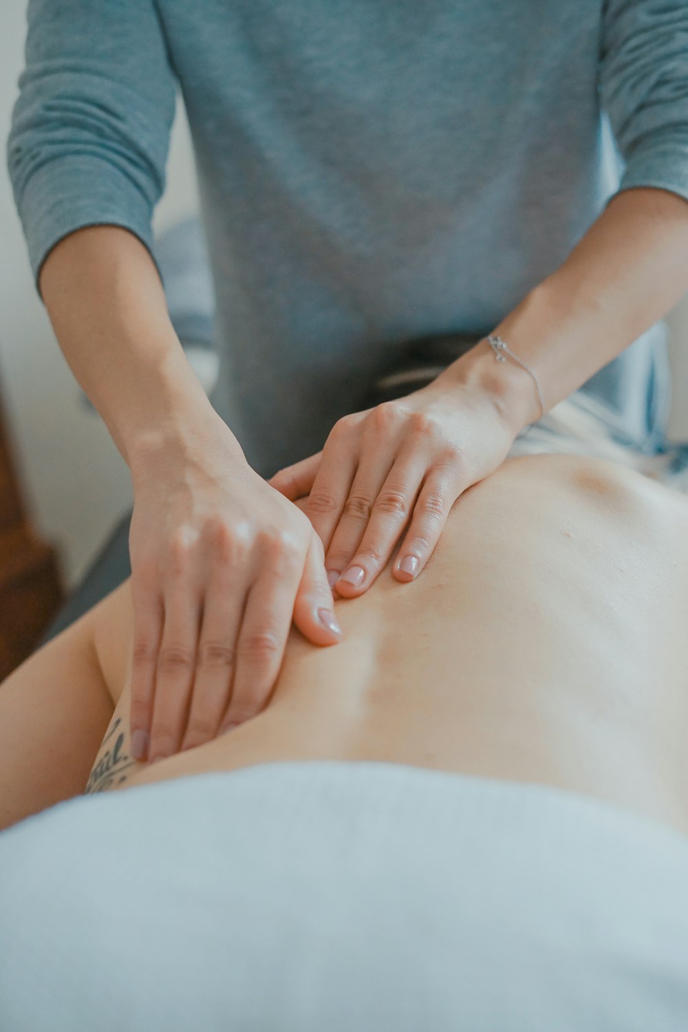 Massage therapist treating a client